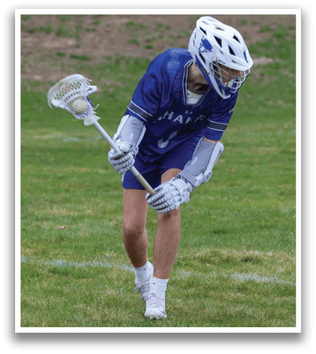 A man in a blue and white uniform is holding a lacrosse stick and preparing to shoot the ball. AI generated content