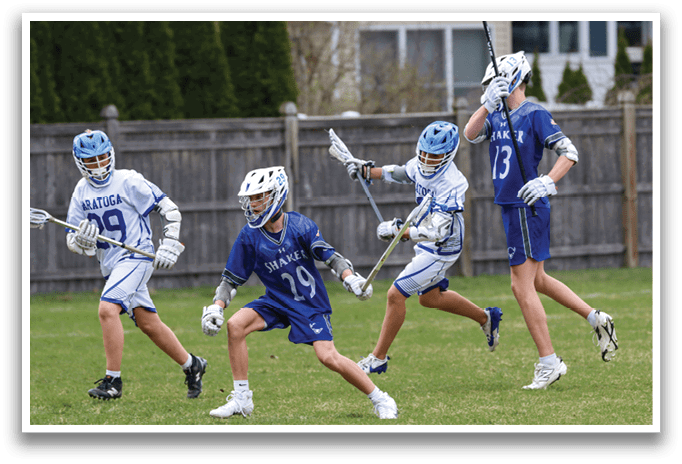 Four young men playing lacrosse on a field. AI generated content