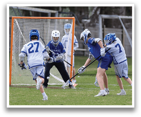 Two boys are playing a game of hockey on a field. One boy is trying to score a goal while the other is trying to defend the goal. AI generated content