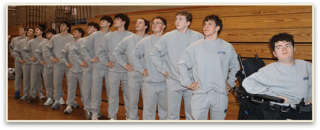 A group of young men wearing grey sweatshirts and white sneakers are standing in a line. AI generated content