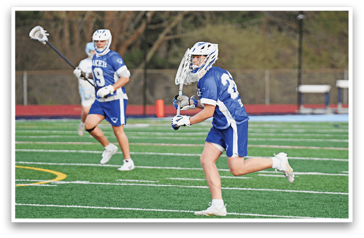 A man in a blue and white uniform is running on a field while holding a lacrosse stick. AI generated content