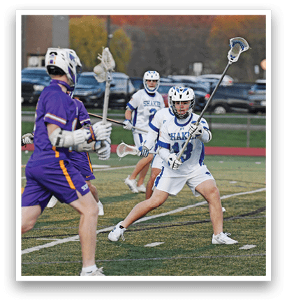 A group of young men playing lacrosse on a field. AI generated content