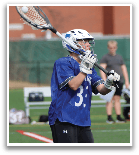 A man wearing a blue and white uniform holds a lacrosse stick, preparing to play. AI generated content