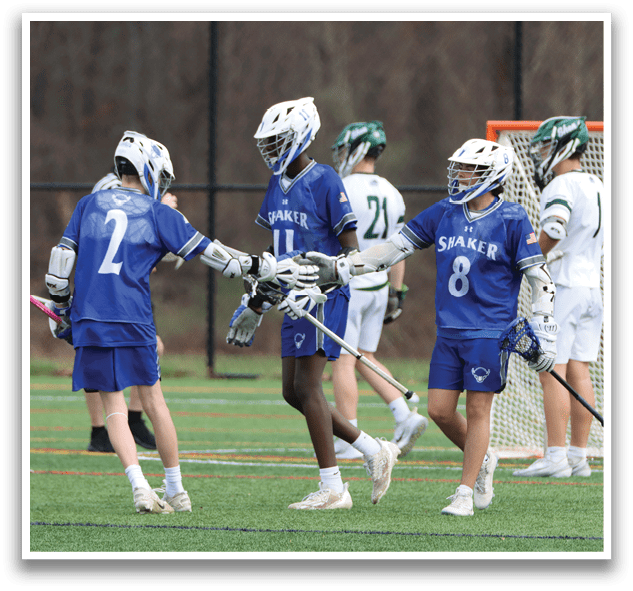 A group of young men wearing blue and white uniforms are playing a game of lacrosse. They are holding their lacrosse sticks and are in the middle of the field. AI generated content