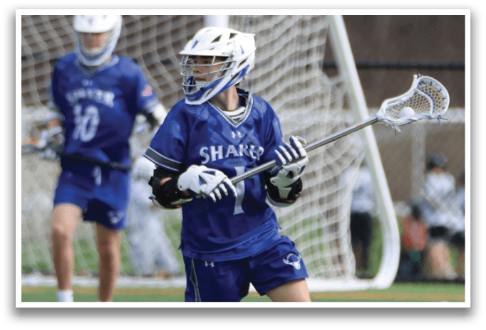 A boy in a blue and white uniform is running with a lacrosse stick. AI generated content