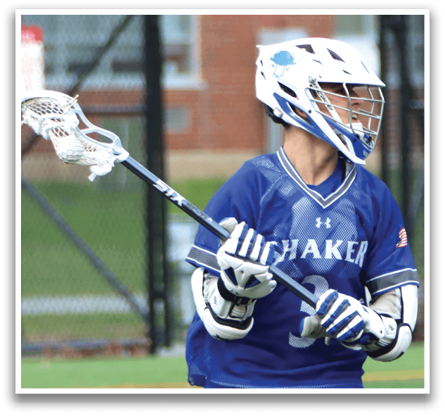A man wearing a blue and white uniform is holding a lacrosse stick and running on a field. AI generated content