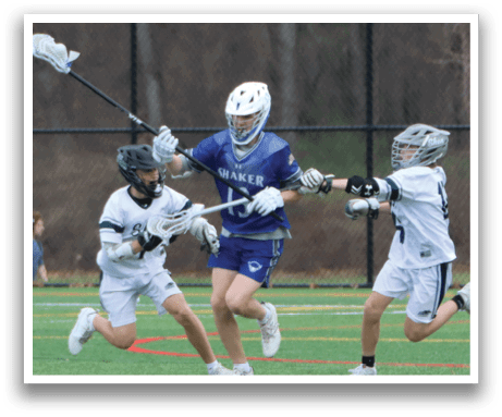 Three young men are playing a game of lacrosse on a field. One player is holding a lacrosse stick, while the other two are running towards him. The players are wearing helmets for safety. AI generated content