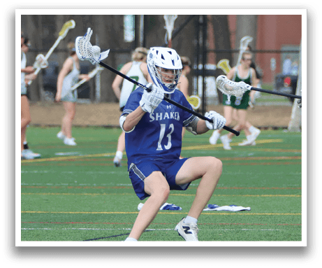 Three young men are playing a game of lacrosse on a field. One player is holding a lacrosse stick, while the other two are running towards him. The players are wearing helmets for safety. AI generated content
