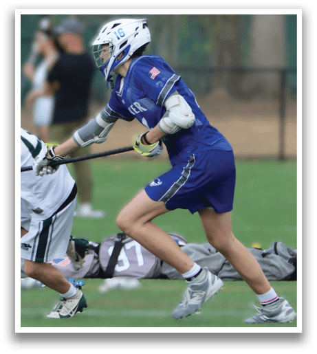 Two men playing lacrosse on a field. One man is trying to get past the other. AI generated content