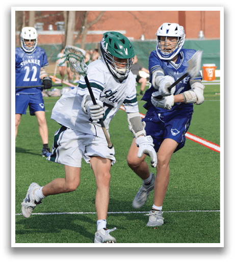Two young men are playing a game of lacrosse on a field. One player is running with a lacrosse stick, while the other player is running with a lacrosse stick and a helmet. AI generated content