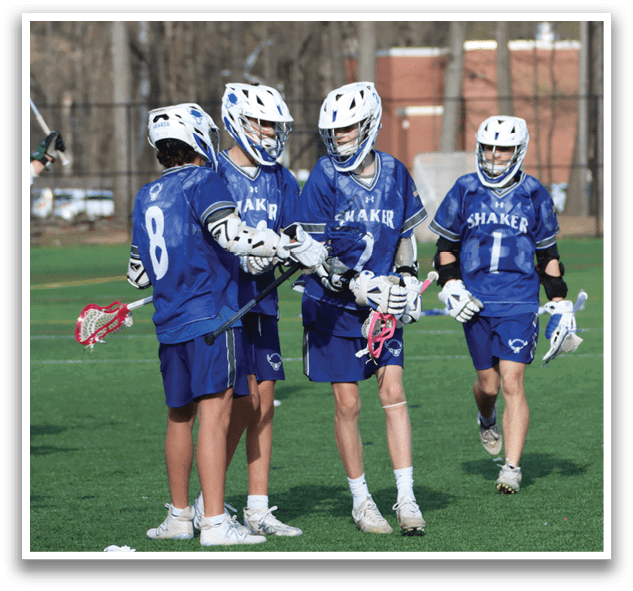 A group of young men wearing blue and white uniforms are standing on a field. They are holding lacrosse sticks and appear to be discussing their next move. AI generated content