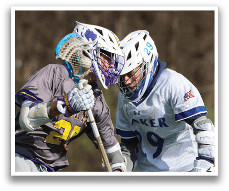 Two boys playing lacrosse. Description generated by AI