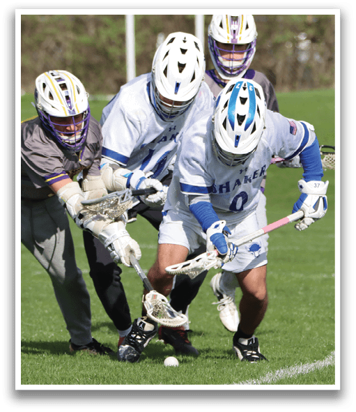A group of people playing lacrosse on a field. Description generated by AI