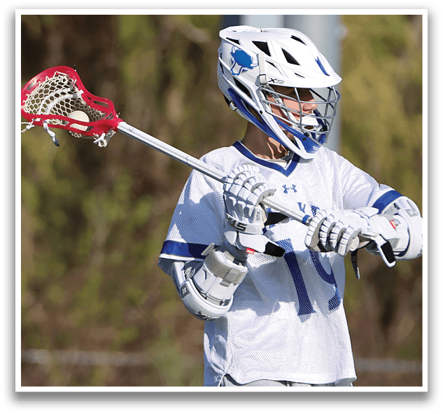 A person holding a lacrosse stick. Description generated by AI