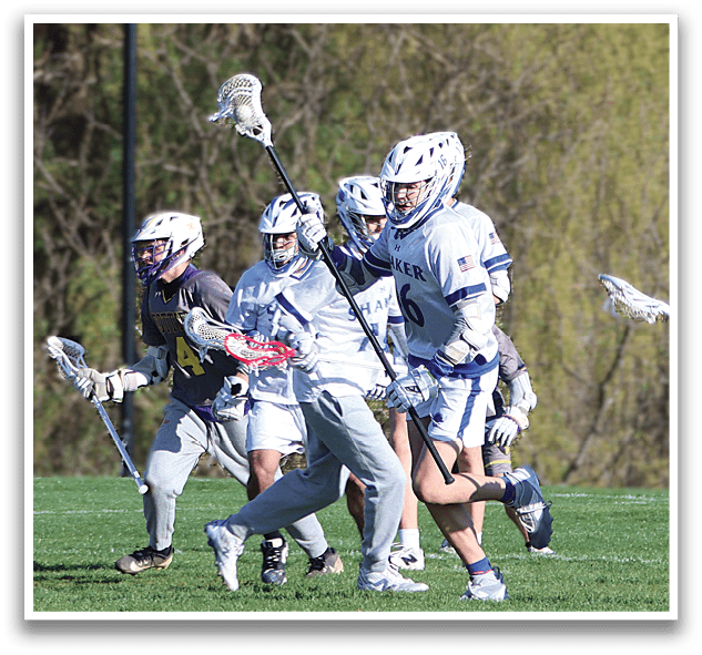 A group of people playing lacrosse on a field. Description generated by AI