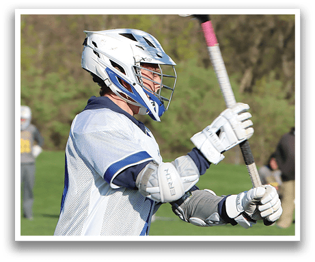 A man holding a lacrosse stick. Description generated by AI