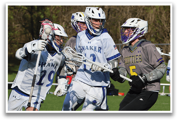 A group of lacrosse players on a field. Description generated by AI