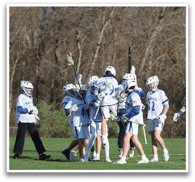A group of people wearing helmets and holding lacrosse sticks. Description generated by AI