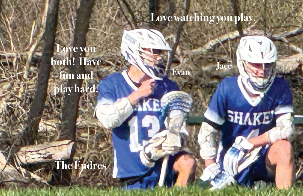 Two boys wearing blue and white jerseys. Description generated by AI