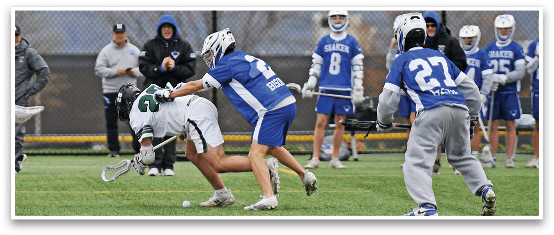 A group of people playing a game of lacrosse. Description generated by AI
