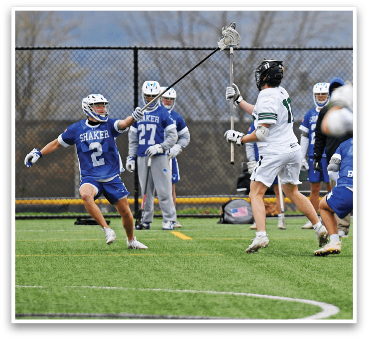 A group of people playing a game of lacrosse. Description generated by AI