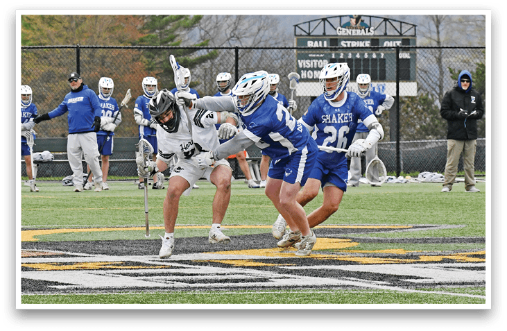 A group of men playing lacrosse. Description generated by AI