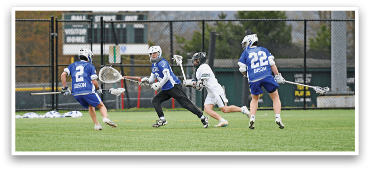 A group of men playing a game of lacrosse. Description generated by AI