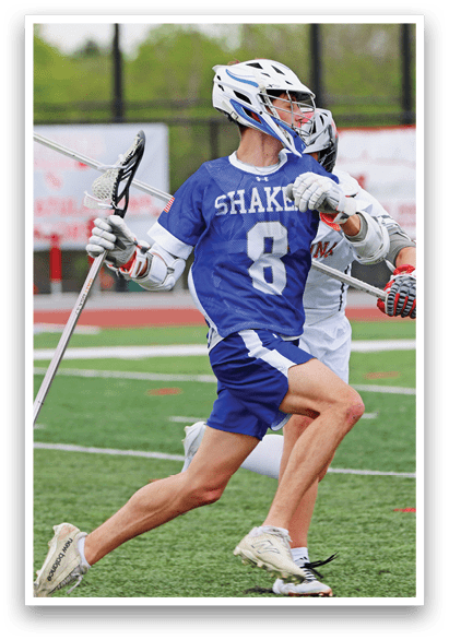 A man wearing a blue and white uniform is running on a field. Description generated by AI