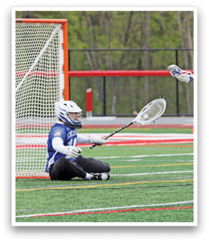 A person is sitting on the ground in front of a goal. Description generated by AI