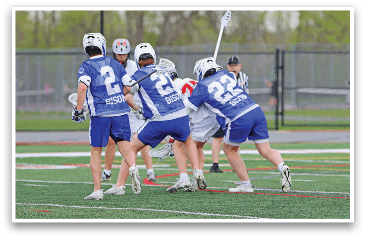 A group of people playing a game of lacrosse. Description generated by AI