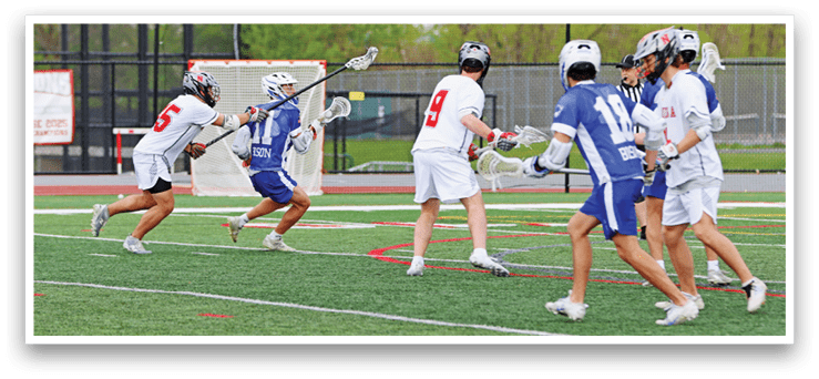 A group of people playing lacrosse on a field. Description generated by AI