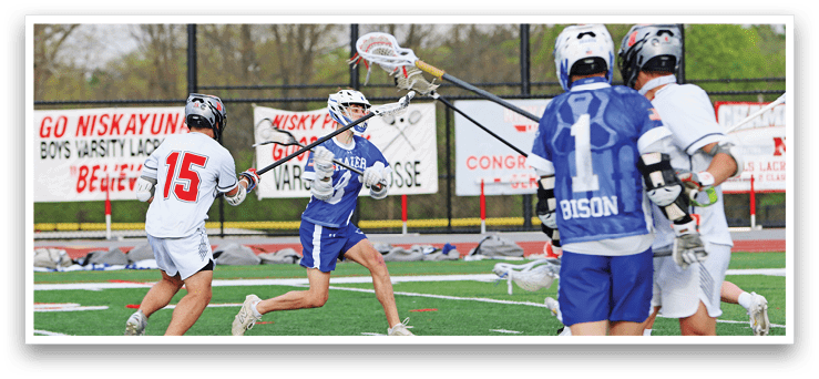 A group of people playing a game of lacrosse. Description generated by AI