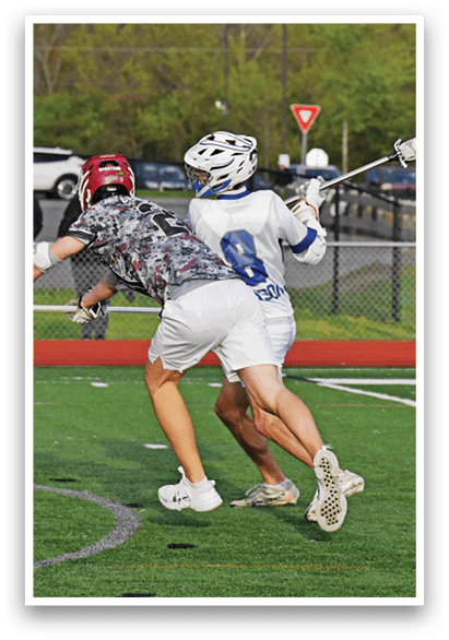 Two men playing a game of lacrosse. Description generated by AI