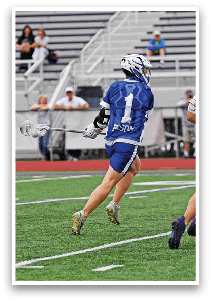A man in a blue shirt and white shorts is running on a field. Description generated by AI
