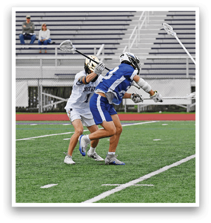 A group of people playing a game of lacrosse on a field. Description generated by AI