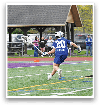 A man wearing a blue shirt and white shorts is running on a field. Description generated by AI