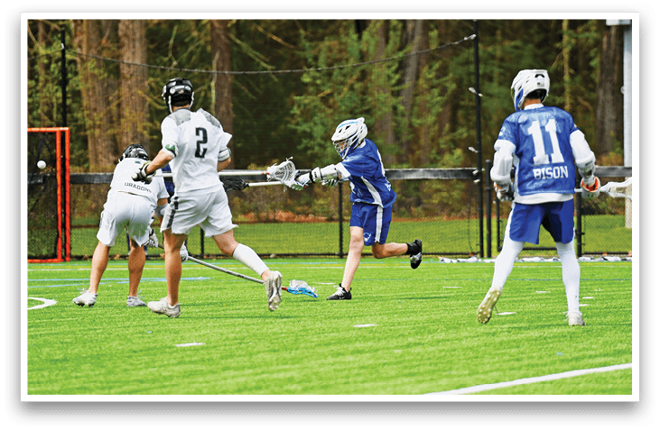 A group of people playing a game of lacrosse. Description generated by AI