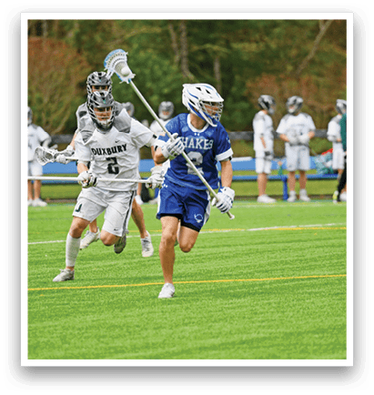 A group of people playing a game of lacrosse on a field. Description generated by AI