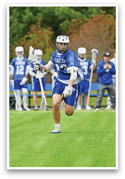 A group of people playing a game of lacrosse. Description generated by AI