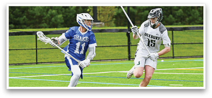 A man wearing a blue and white uniform is running with a lacrosse stick. Description generated by AI