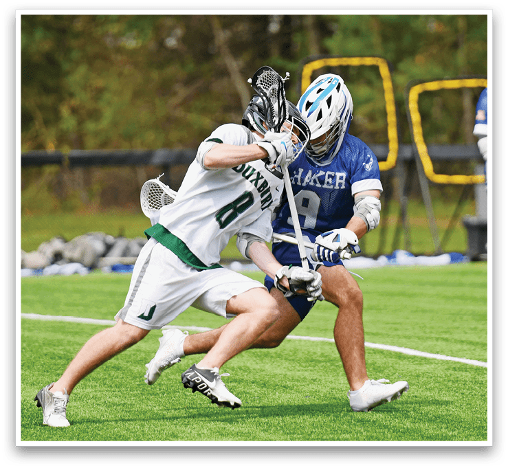 A man in a green and white jersey is trying to get past another player. Description generated by AI