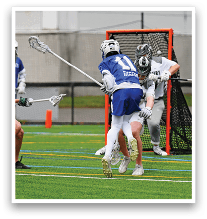 A group of people playing lacrosse on a field. Description generated by AI
