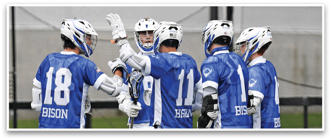 A group of men wearing blue and white uniforms are standing on a field. Description generated by AI