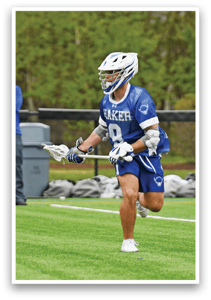 A man in a blue and white uniform is running on a field. Description generated by AI