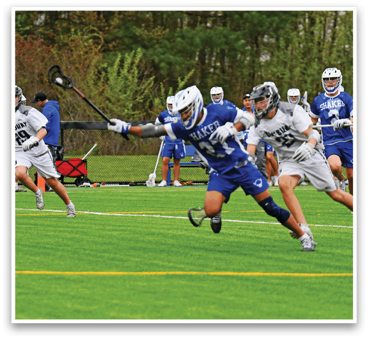 A group of people playing lacrosse on a field. Description generated by AI