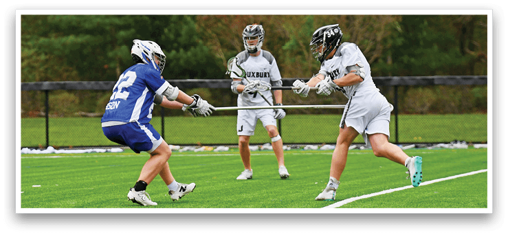 A group of men playing a game of lacrosse. Description generated by AI