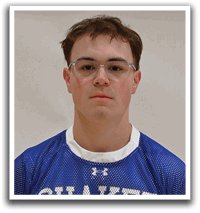 A young man wearing a blue and white shaker jersey. Description generated by AI