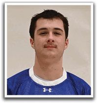 A young man wearing a blue and white shaker jersey. Description generated by AI