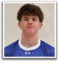 A young man wearing a blue and white shaker jersey. Description generated by AI