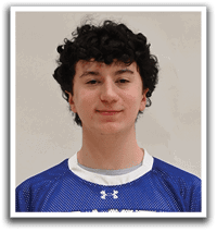 A young man wearing a blue and white shaker jersey. Description generated by AI